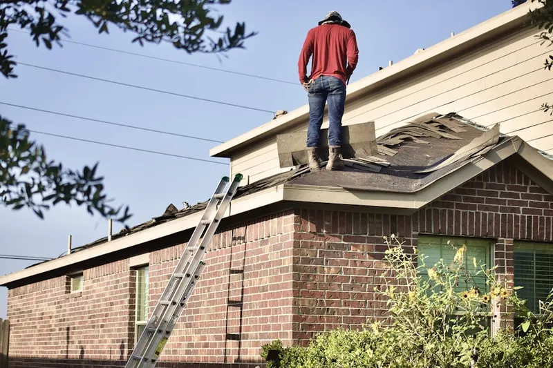 Professional roofer working on a residential roof in Belmont Shore